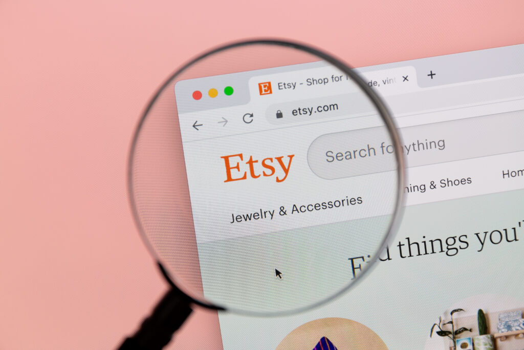 A magnifying glass taking a closer look on how to sell more products on Etsy. 